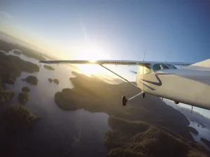 AAG aircraft flying above coastal area