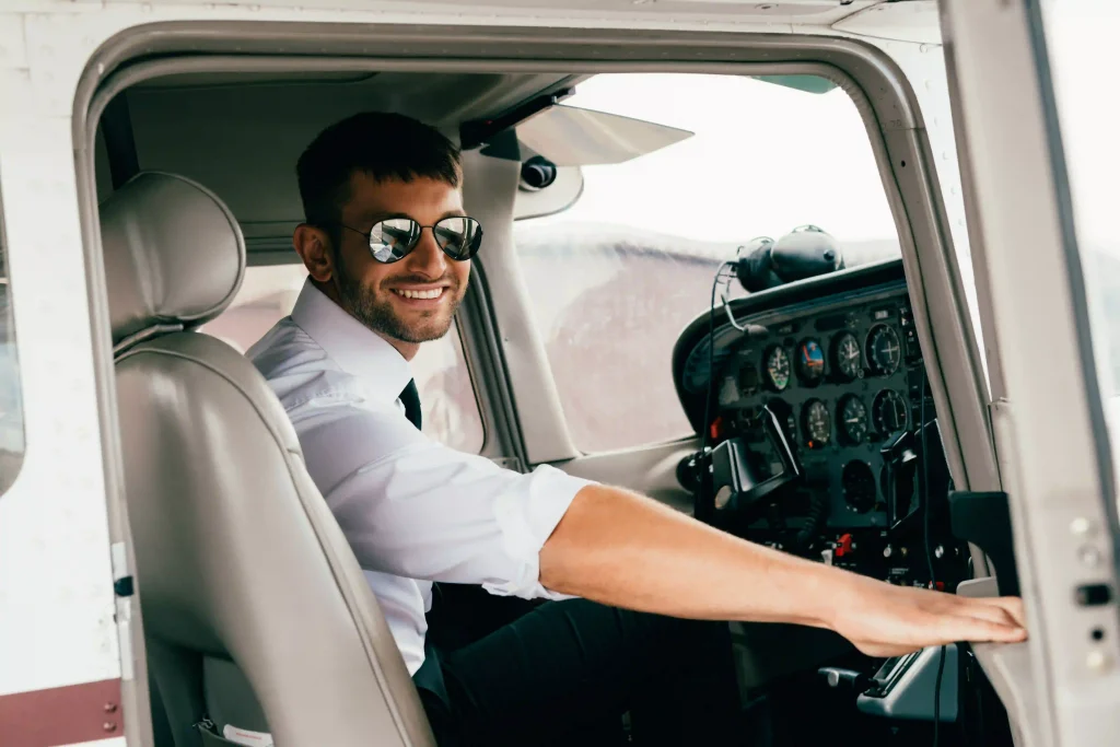 Smiling pilot cadet on training aircraft